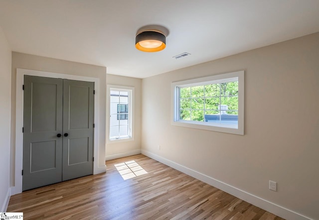 11 Stall St, Greenville, SC 29609 - unfurnished bedroom featuring baseboards, wood finished floors, and a closet