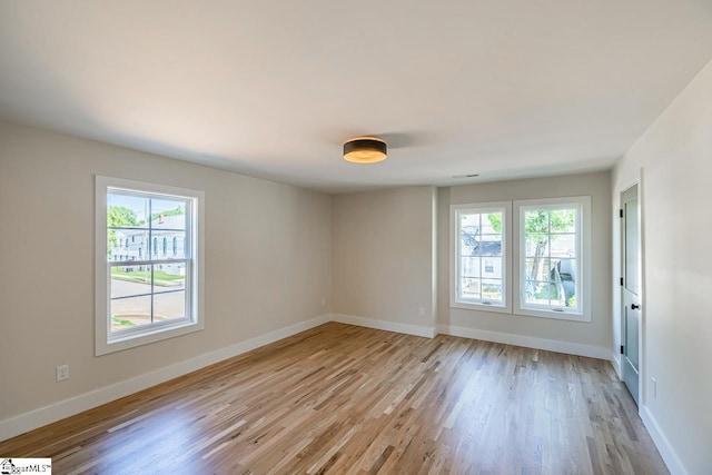 11 Stall St, Greenville, SC 29609 - spare room featuring healthy amount of natural light, light wood-style floors, and baseboards