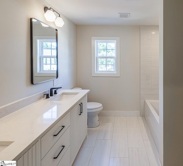 11 Stall St, Greenville, SC 29609 - bathroom featuring vanity, toilet, and baseboards