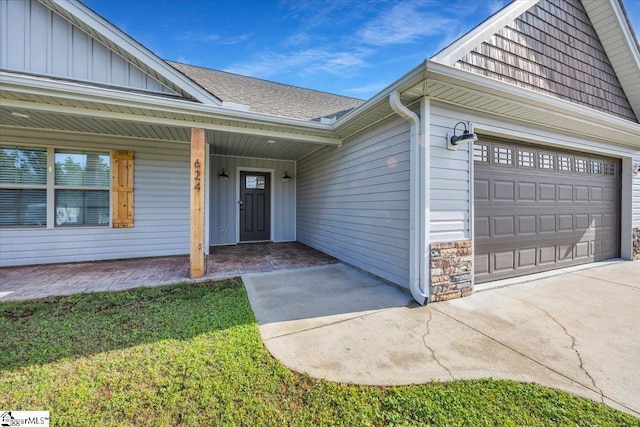 624 Renita Dr, Boiling Springs, SC 29316 - doorway to property featuring board and batten siding, stone siding, a garage, and driveway