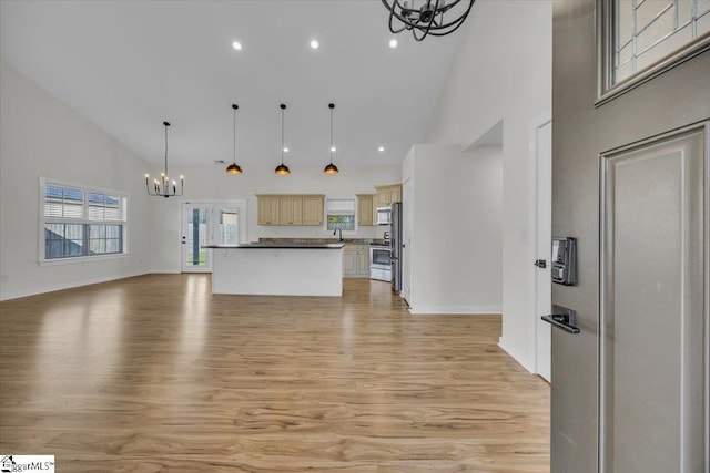 624 Renita Dr, Boiling Springs, SC 29316 - kitchen featuring a chandelier, open floor plan, high vaulted ceiling, light wood-type flooring, and appliances with stainless steel finishes