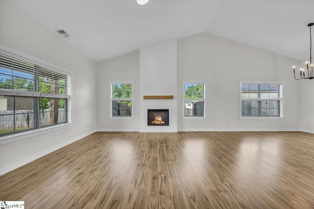 624 Renita Dr, Boiling Springs, SC 29316 - unfurnished living room with a chandelier, healthy amount of natural light, high vaulted ceiling, a large fireplace, and wood finished floors