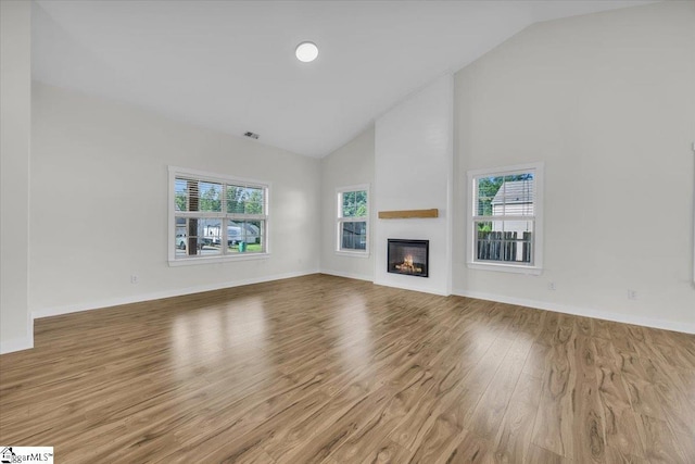 624 Renita Dr, Boiling Springs, SC 29316 - unfurnished living room with wood finished floors, high vaulted ceiling, a large fireplace, and baseboards