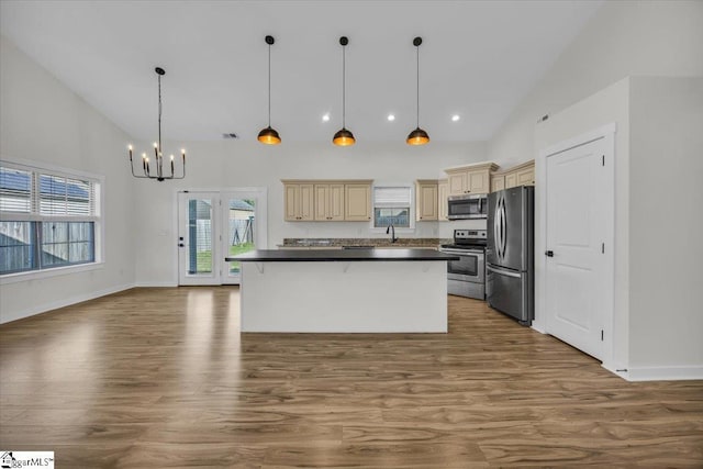624 Renita Dr, Boiling Springs, SC 29316 - kitchen featuring stainless steel appliances, cream cabinetry, high vaulted ceiling, dark countertops, and wood finished floors