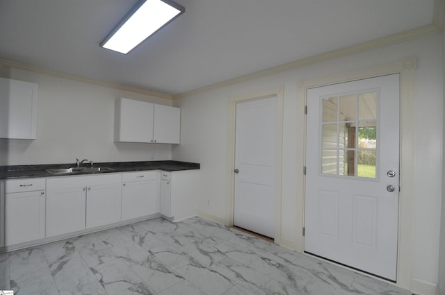 105 S Oakleaf Dr, Landrum, SC 29356 - kitchen with a sink, light marble finish floors, crown molding, white cabinets, and dark countertops