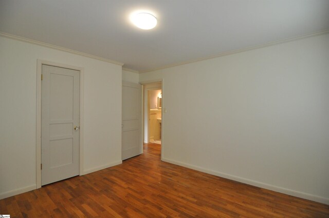 105 S Oakleaf Dr, Landrum, SC 29356 - unfurnished bedroom with crown molding, dark wood finished floors, and baseboards
