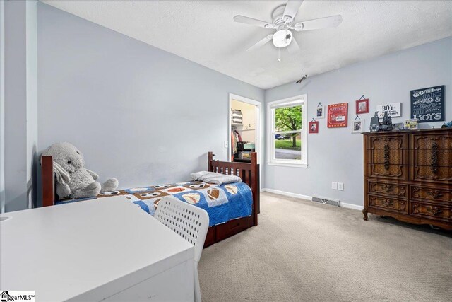 116 Kennedy St, Easley, SC 29642 - carpeted bedroom with baseboards, a ceiling fan, and a textured ceiling
