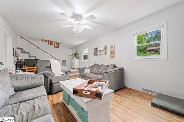 116 Kennedy St, Easley, SC 29642 - living room featuring plenty of natural light, stairway, light wood-style flooring, and a ceiling fan
