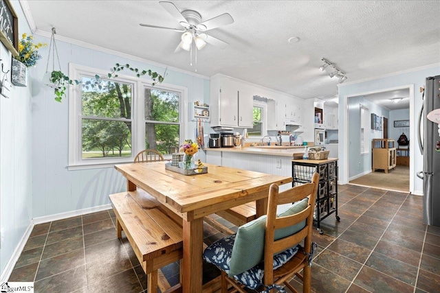116 Kennedy St, Easley, SC 29642 - dining room featuring baseboards, crown molding, a ceiling fan, dark stone finish flooring, and a textured ceiling