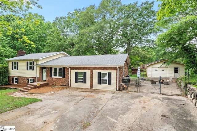 116 Kennedy St, Easley, SC 29642 - tri-level home featuring a gate, brick siding, a chimney, an outbuilding, and roof with shingles