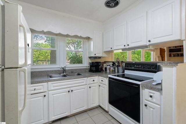 2807 Bellview Rd, Anderson, SC 29621 - kitchen with freestanding refrigerator, range with electric cooktop, a sink, light tile patterned floors, and white cabinetry