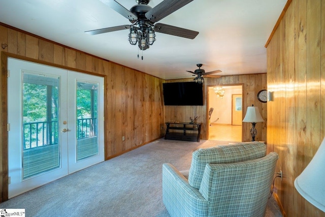 345 P Cromer Rd, Abbeville, SC 29620 - living area featuring wood walls, carpet floors, french doors, and a ceiling fan
