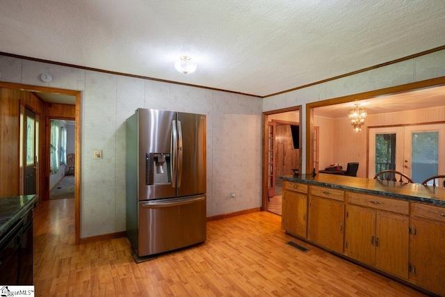 345 P Cromer Rd, Abbeville, SC 29620 - kitchen with stainless steel fridge, brown cabinets, light wood-style floors, a textured ceiling, and dark countertops