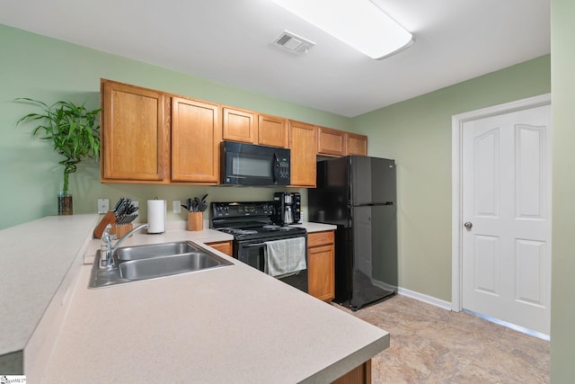 9 Hollow Tree Way, Greenville, SC 29605 - kitchen featuring black appliances, a sink, light countertops, brown cabinetry, and baseboards