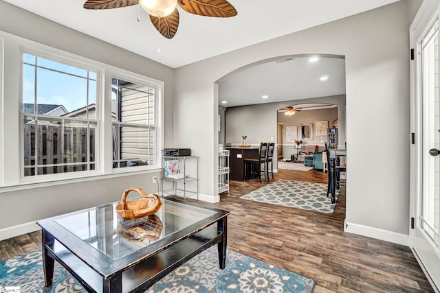 105 Devonfield Dr, Greer, SC 29651 - living room featuring ceiling fan, arched walkways, wood finished floors, baseboards, and healthy amount of natural light