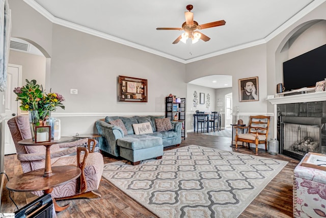 105 Devonfield Dr, Greer, SC 29651 - living room featuring arched walkways, ceiling fan, wood finished floors, crown molding, and a tiled fireplace