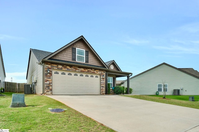 105 Devonfield Dr, Greer, SC 29651 - craftsman house with central air condition unit, driveway, a front lawn, and stone siding