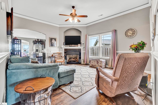 105 Devonfield Dr, Greer, SC 29651 - living room with a ceiling fan, arched walkways, crown molding, wood finished floors, and a fireplace