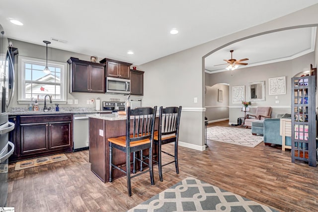 105 Devonfield Dr, Greer, SC 29651 - kitchen with arched walkways, stainless steel appliances, a sink, ceiling fan, and dark brown cabinets