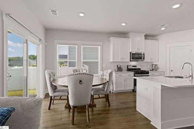 117 Hazelcroft Dr, Fountain Inn, SC 29644 - kitchen with stainless steel appliances, a sink, dark wood-style floors, light countertops, and recessed lighting
