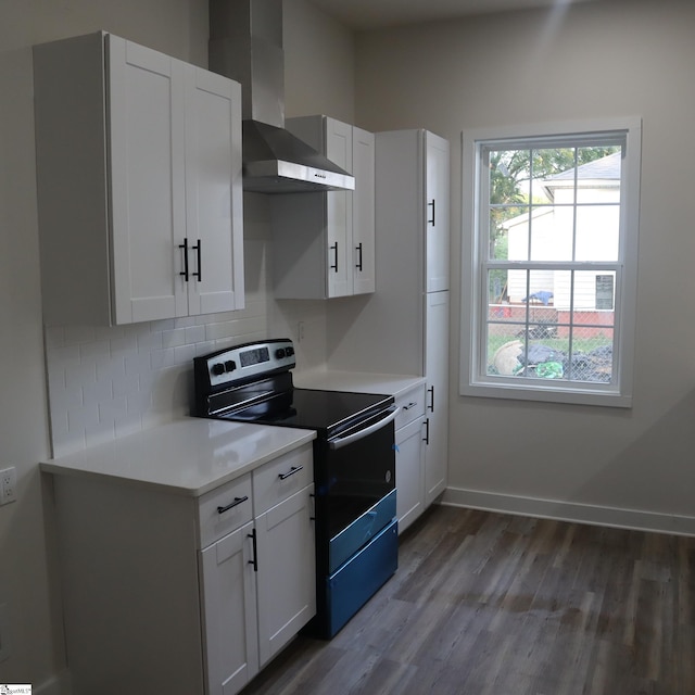 205 Magnolia St, Gaffney, SC 29340 - kitchen with electric stove, wall chimney exhaust hood, wood finished floors, decorative backsplash, and light countertops