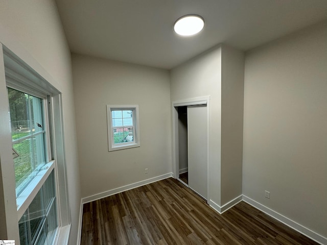 205 Magnolia St, Gaffney, SC 29340 - unfurnished bedroom with dark wood-style flooring, baseboards, and a closet