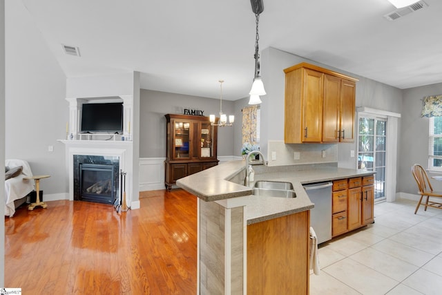 103 Circle Grove Ct, Greer, SC 29650 - kitchen featuring a sink, dishwasher, a chandelier, a peninsula, and hanging light fixtures