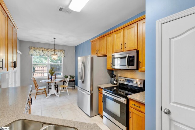 103 Circle Grove Ct, Greer, SC 29650 - kitchen with stainless steel appliances, light tile patterned flooring, hanging light fixtures, light countertops, and tasteful backsplash