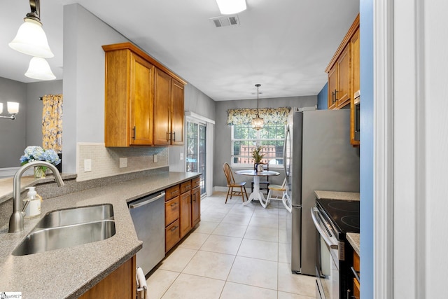 103 Circle Grove Ct, Greer, SC 29650 - kitchen featuring stainless steel appliances, a sink, brown cabinets, and light tile patterned flooring