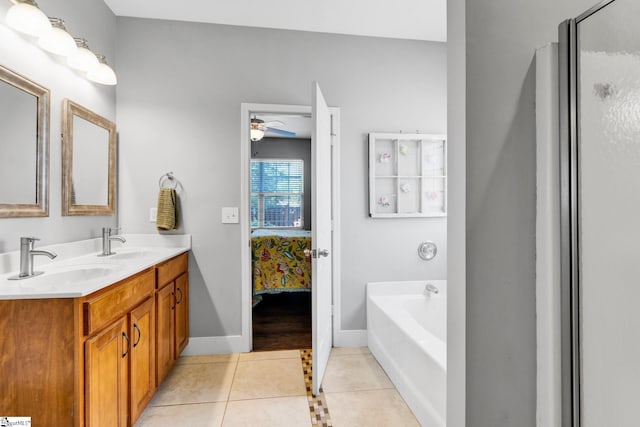103 Circle Grove Ct, Greer, SC 29650 - ensuite bathroom with a garden tub, tile patterned floors, double vanity, ceiling fan, and baseboards