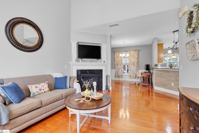 103 Circle Grove Ct, Greer, SC 29650 - living area featuring a chandelier, light wood finished floors, a high end fireplace, and baseboards