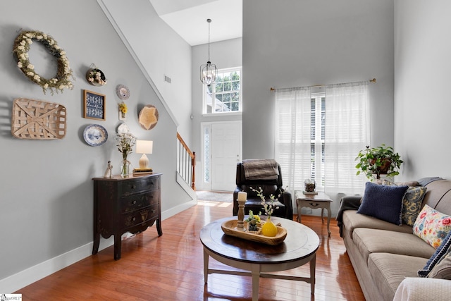 103 Circle Grove Ct, Greer, SC 29650 - living area featuring stairway, a high ceiling, a chandelier, wood finished floors, and baseboards