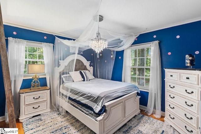 3 Creighton Ct, Taylors, SC 29687 - bedroom with a chandelier, baseboards, and light wood-type flooring