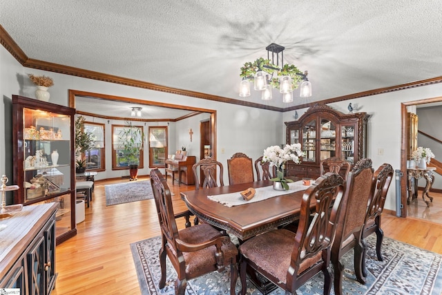 208 Forrester Creek Way, Greenville, SC 29607 - dining space featuring a chandelier, light wood-type flooring, a textured ceiling, crown molding, and baseboards