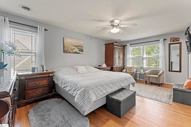 208 Forrester Creek Way, Greenville, SC 29607 - bedroom with light wood-style floors, a textured ceiling, and ceiling fan
