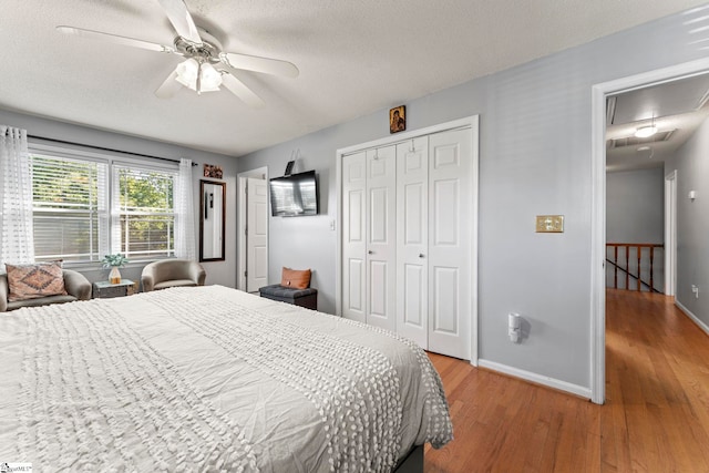 208 Forrester Creek Way, Greenville, SC 29607 - bedroom featuring attic access, light wood-type flooring, baseboards, a closet, and a textured ceiling