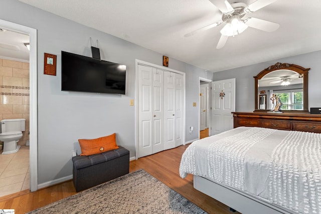 208 Forrester Creek Way, Greenville, SC 29607 - bedroom featuring wood finished floors, a closet, ceiling fan, ensuite bath, and tile walls