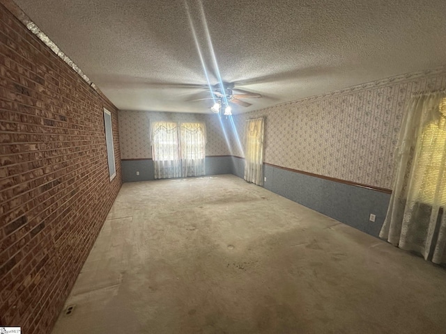 148 Southland Ave, Boiling Springs, SC 29316 - spare room featuring wallpapered walls, a textured ceiling, wainscoting, a ceiling fan, and carpet floors