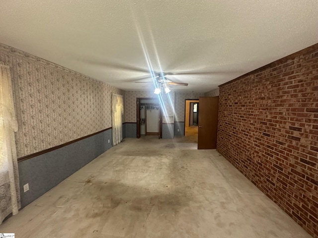 148 Southland Ave, Boiling Springs, SC 29316 - spare room featuring wallpapered walls, a ceiling fan, a wainscoted wall, and a textured ceiling