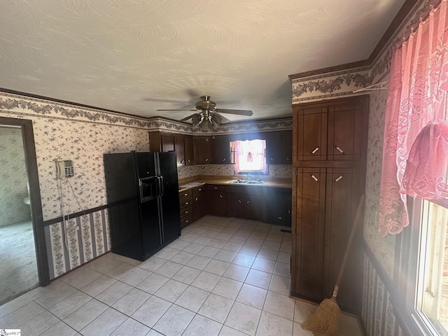 148 Southland Ave, Boiling Springs, SC 29316 - kitchen with wallpapered walls, black fridge, ceiling fan, light tile patterned floors, and a sink