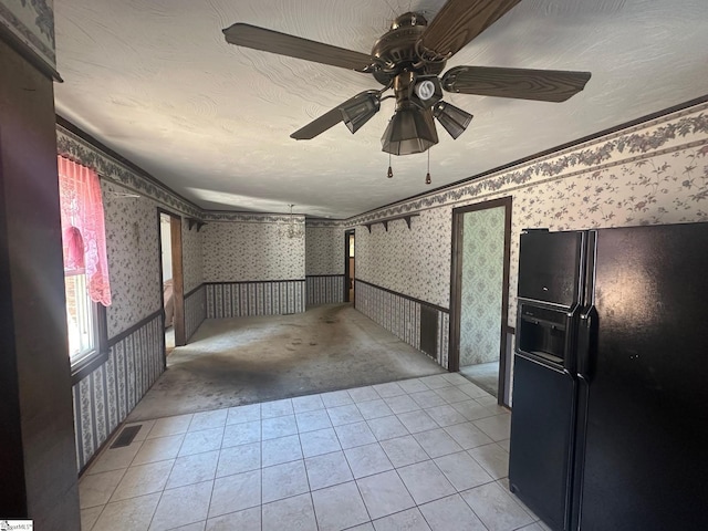 148 Southland Ave, Boiling Springs, SC 29316 - spare room featuring wallpapered walls, a ceiling fan, light colored carpet, light tile patterned flooring, and wainscoting