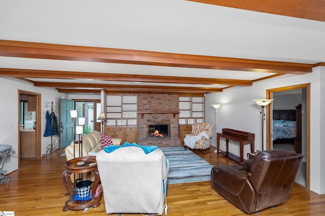 223 Covington Rd, Greenville, SC 29617 - living area with beamed ceiling, light wood-style floors, and a fireplace