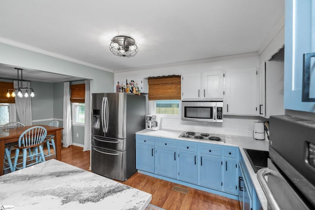 110 Sycamore Dr, Mauldin, SC 29662 - kitchen featuring appliances with stainless steel finishes, a chandelier, blue cabinets, light countertops, and healthy amount of natural light