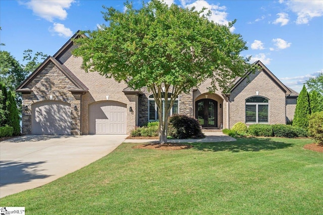 135 Neal Pointe Dr, Chesnee, SC 29323 - view of front facade featuring french doors, a front lawn, concrete driveway, a garage, and stone siding