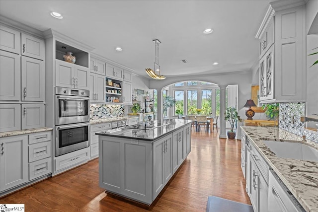 135 Neal Pointe Dr, Chesnee, SC 29323 - kitchen featuring open shelves, stainless steel double oven, decorative columns, a sink, and tasteful backsplash