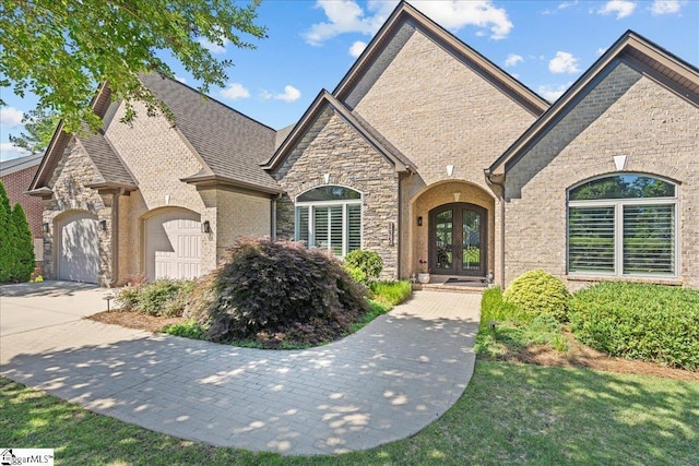 135 Neal Pointe Dr, Chesnee, SC 29323 - french country home with french doors, a garage, driveway, and stone siding