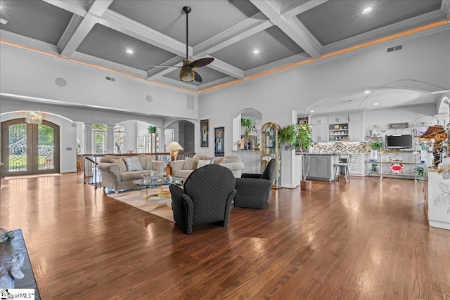 135 Neal Pointe Dr, Chesnee, SC 29323 - living room featuring a high ceiling, arched walkways, a ceiling fan, ornamental molding, and coffered ceiling