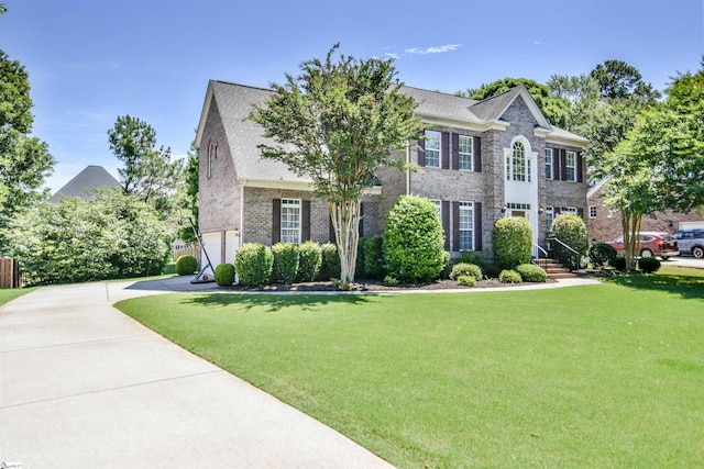 225 Highgrove Ct, Simpsonville, SC 29681 - colonial home featuring a front yard, brick siding, concrete driveway, and an attached garage