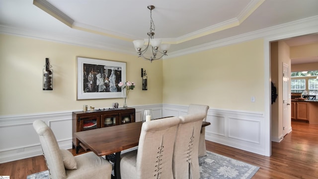 225 Highgrove Ct, Simpsonville, SC 29681 - dining area featuring a chandelier, crown molding, wainscoting, and wood finished floors