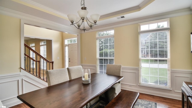 225 Highgrove Ct, Simpsonville, SC 29681 - dining room with a chandelier, a wainscoted wall, wood finished floors, stairs, and a decorative wall